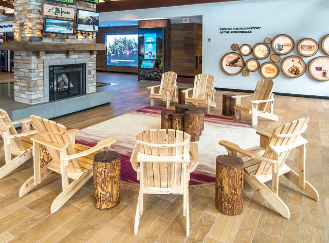 Adirondack chairs and a fireplace on display at the Adirondack Welcome Center on North side of Route I 87