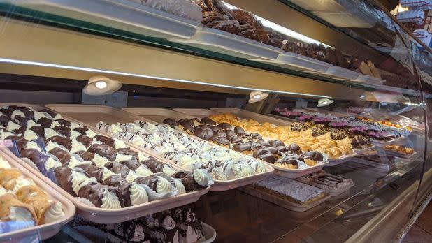 Italian desserts inside a glass display case.