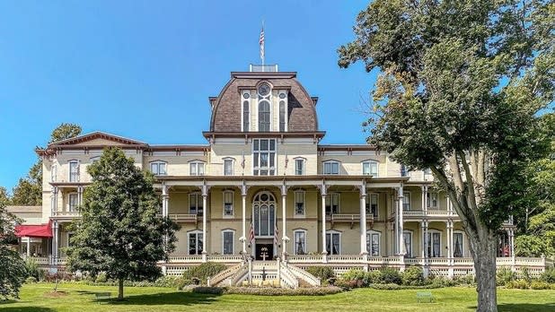 The Chautauqua Institution on surrounded by green grass and blue skies