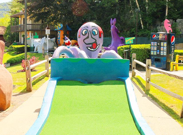 Statue of a giant purple octopus at one of the holes at Goony Golf & Castle Arcade