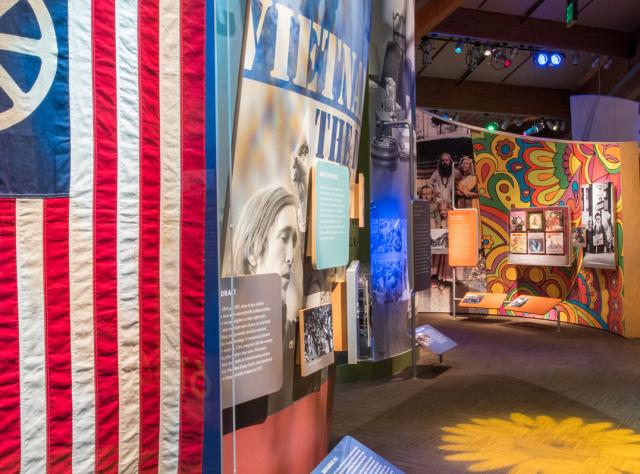 A look at the inside of the Museum at Bethel Woods displays and American flag with peace sign