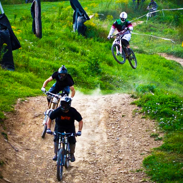 Three bikers riding around Plattekill Bike Park