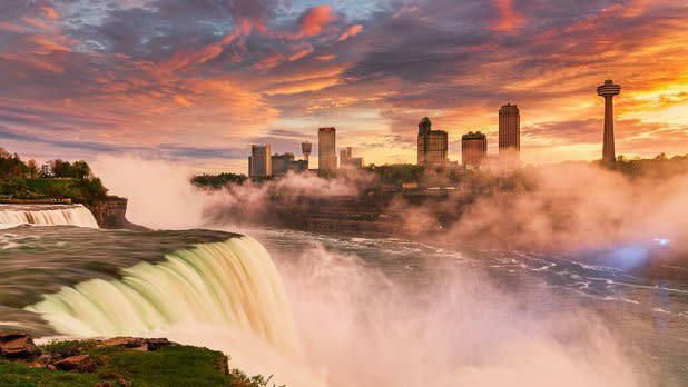 Waters race down Niagara Falls at sunset