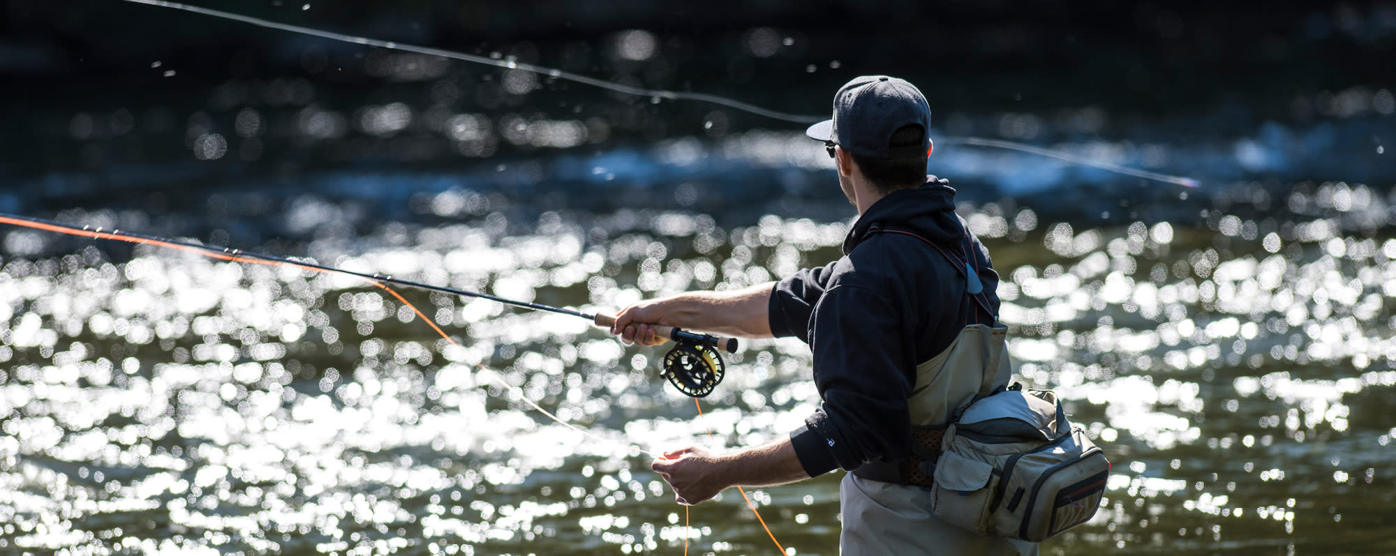 A man fly fishing in the Salmon River in Pulaski