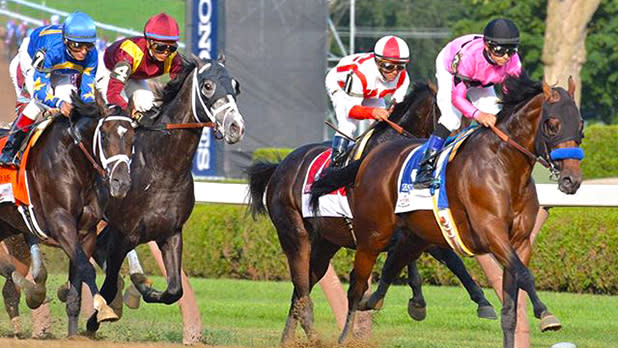 A group of jockeys riding horses at the Saratoga Race Track