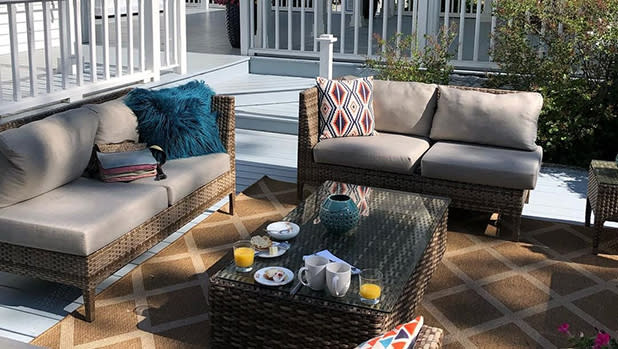 An outdoor area with two sofas and a table