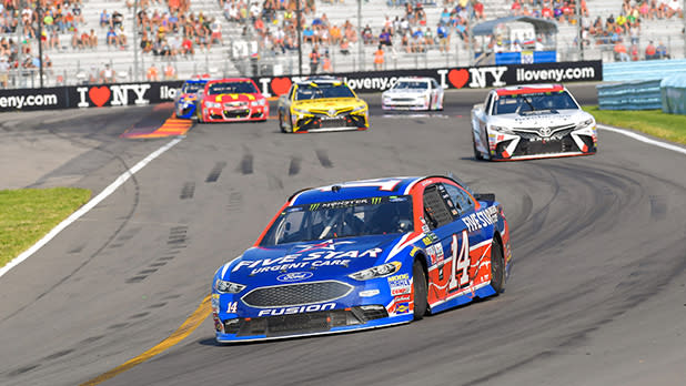 Several cars racing around the track at Watkins Glen International