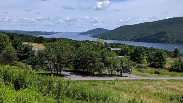 Rolling hills and mountains with trees and a view of the lake at Urbana State Forest